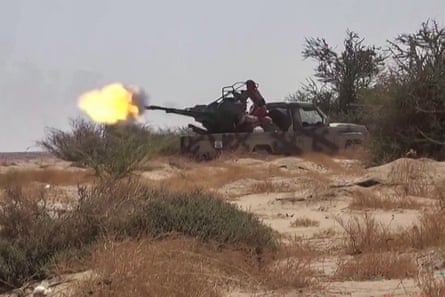 A view of a large gun being fired from the back of a flatbed truck