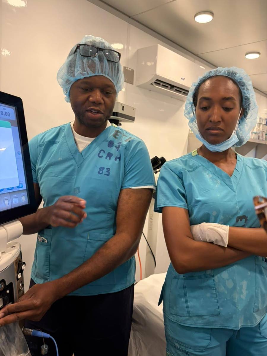 Ophthalmologist Dr David Burton (left) makes a point to Nurse Saschauna Hamilton during a medical mission at the Cornwall Regional Hospital in Montego Bay earlier this year.