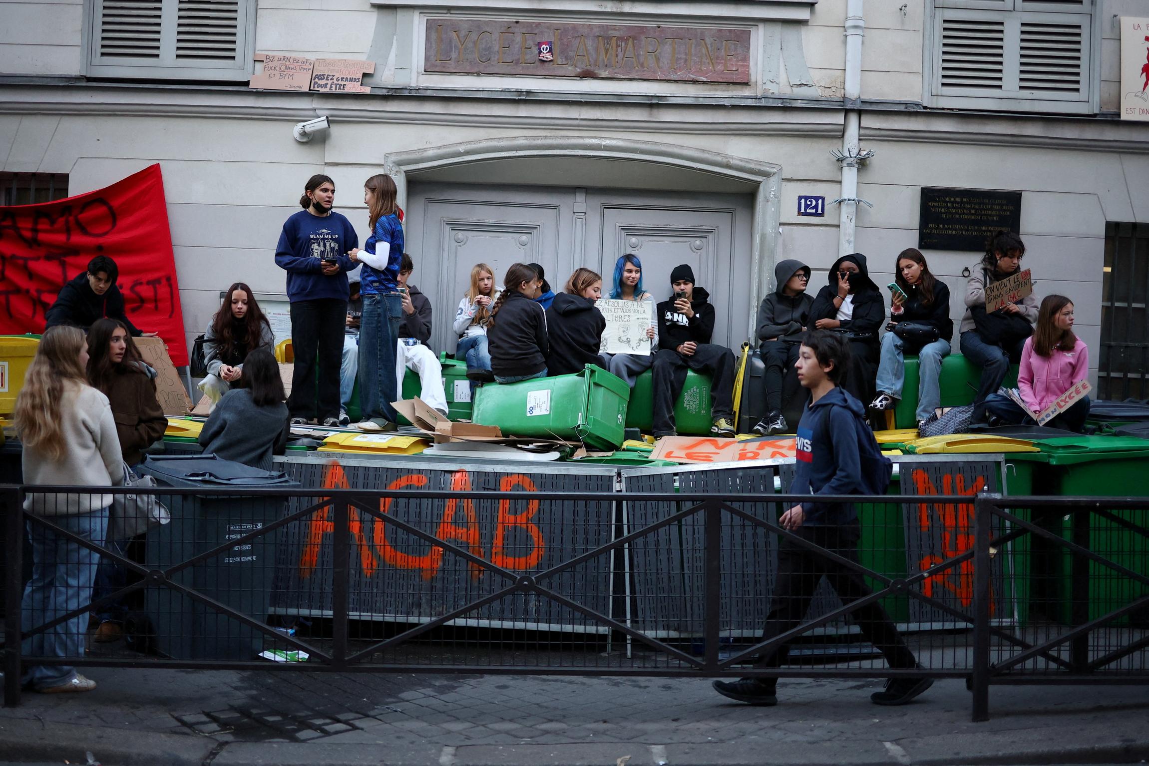 French high school students sit on barricades outside the Lycée Lamartine in Paris, as part of nationwide protests to demand better school conditions in France, October 8, 2026. TPX IMAGES OF THE DAY